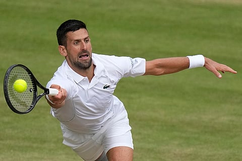 Novak Djokovic plays a forehand return to Carlos Alcaraz